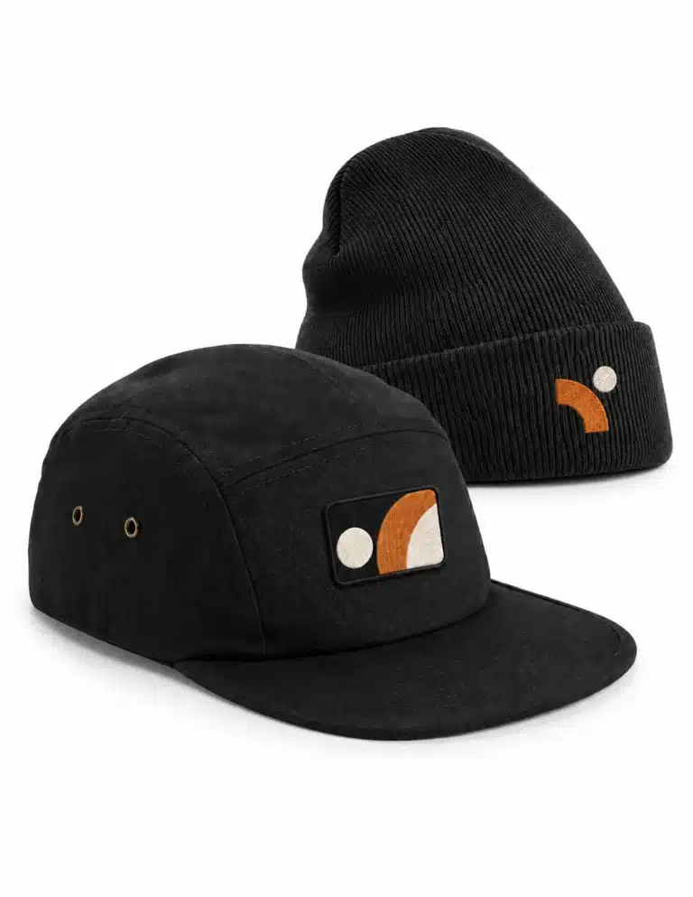 Black cap with a geometric patch and black beanie with orange and white embroidery