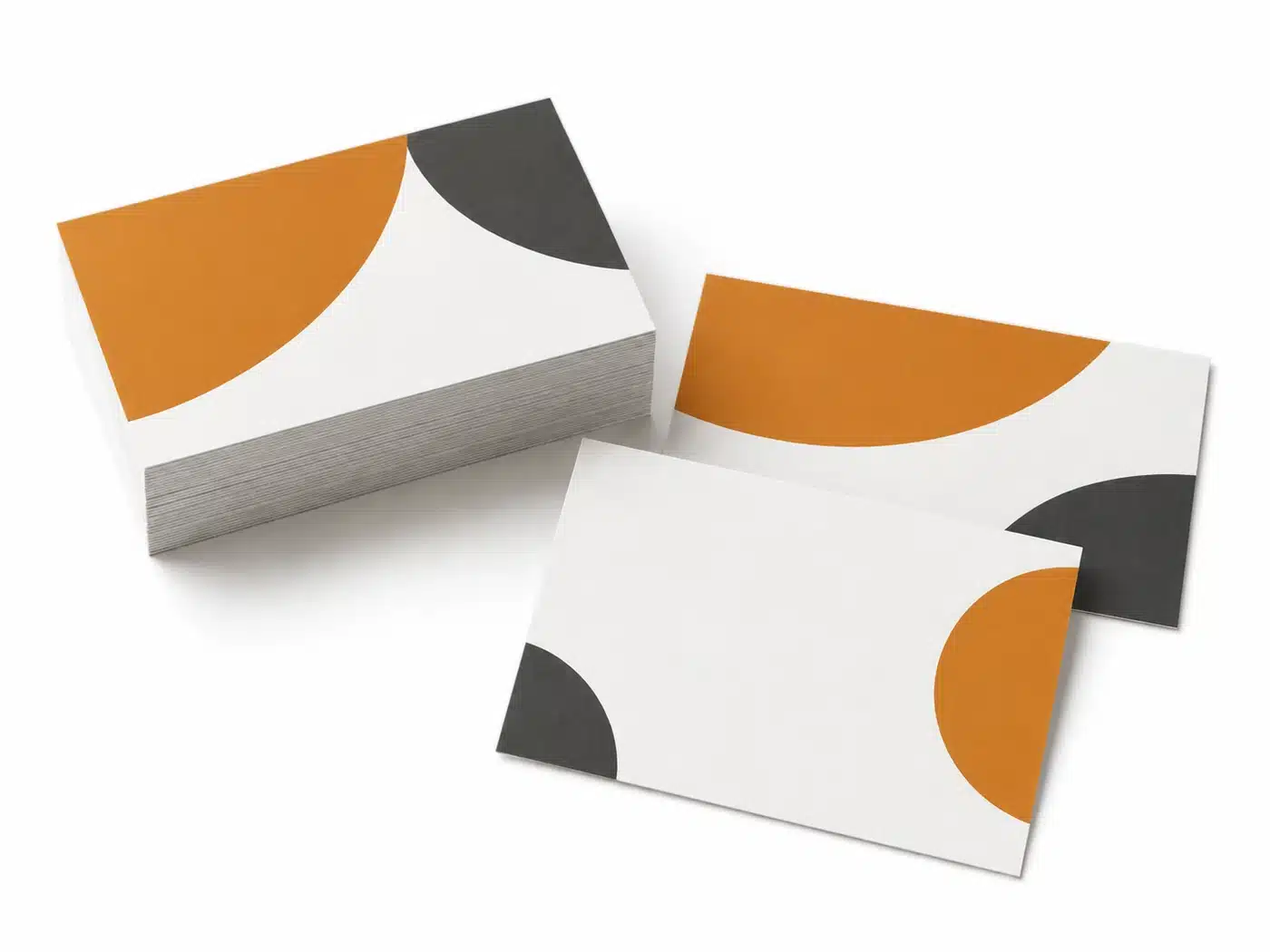Stack of business cards and two individual cards with orange and black geometric designs on white, product visualisation